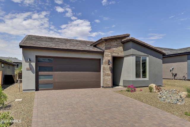 4320 Sawbuck Way, Wickenburg, AZ 85390 - prairie-style house with stone siding, an attached garage, stucco siding, and decorative driveway