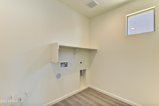 laundry area with washer hookup, gas dryer hookup, light hardwood / wood-style flooring, and hookup for an electric dryer