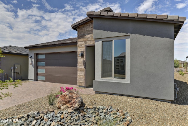 4320 Sawbuck Way, Wickenburg, AZ 85390 - exterior space with driveway, stucco siding, a garage, and stone siding