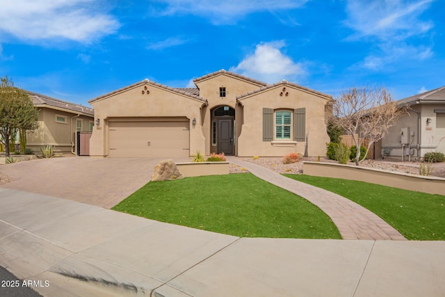 mediterranean / spanish house featuring an attached garage, a tiled roof, decorative driveway, stucco siding, and a front yard