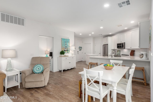 2511 W Queen Creek Rd Unit 174, Chandler, AZ 85248 - dining room featuring light wood-style floors, recessed lighting, and baseboards