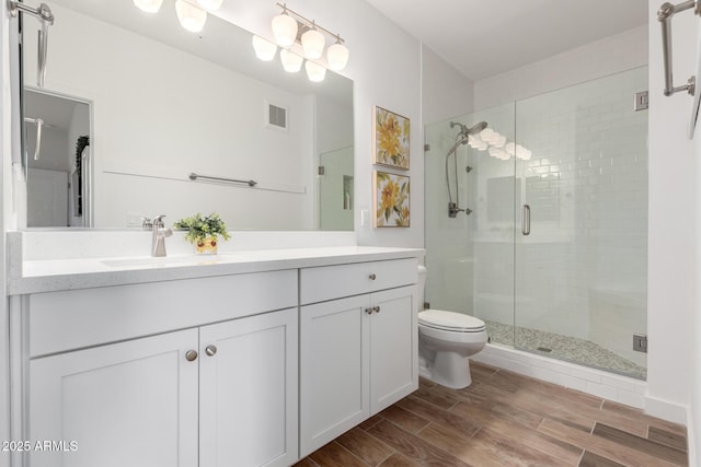 2511 W Queen Creek Rd Unit 174, Chandler, AZ 85248 - bathroom featuring toilet, vanity, a shower stall, and wood finished floors