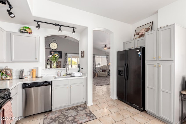 kitchen with lofted ceiling, arched walkways, ceiling fan, black fridge with ice dispenser, and stainless steel dishwasher