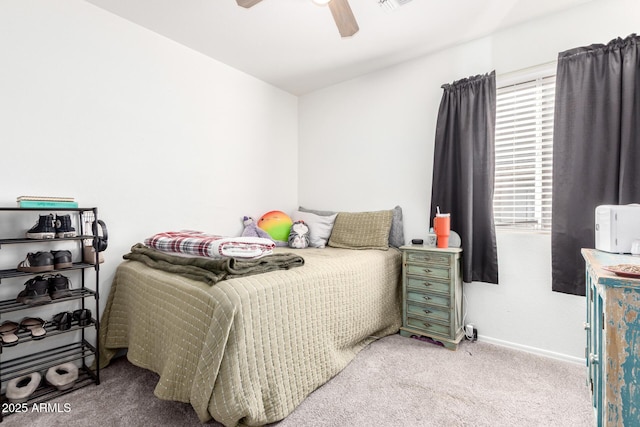 carpeted bedroom featuring visible vents, baseboards, and ceiling fan