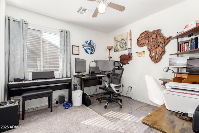 home office with visible vents, ceiling fan, and carpet floors