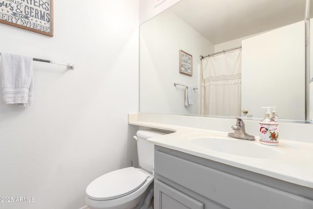 full bathroom with toilet and vanity