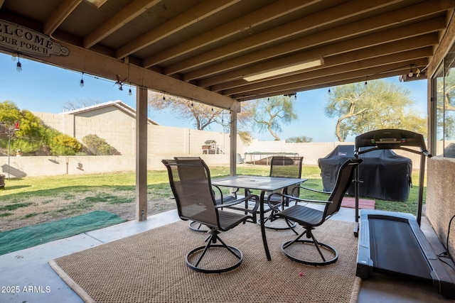 view of patio with grilling area, outdoor dining space, and a fenced backyard