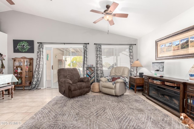 living area with lofted ceiling, a ceiling fan, and a wealth of natural light