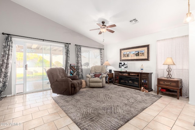 living room with light tile patterned floors, visible vents, a ceiling fan, and lofted ceiling