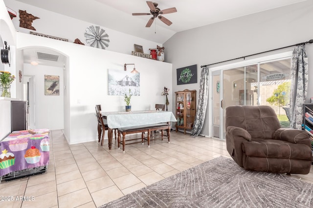 dining space featuring visible vents, arched walkways, light tile patterned floors, lofted ceiling, and ceiling fan