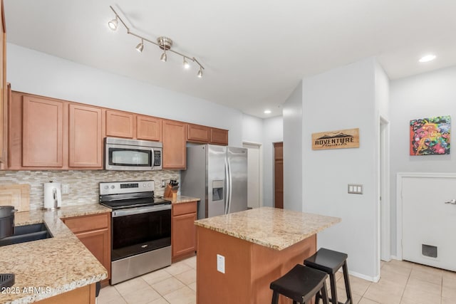1350 S Greenfield Rd Unit 1005, Mesa, AZ 85206 - kitchen featuring stainless steel appliances, light tile patterned floors, tasteful backsplash, a breakfast bar, and recessed lighting
