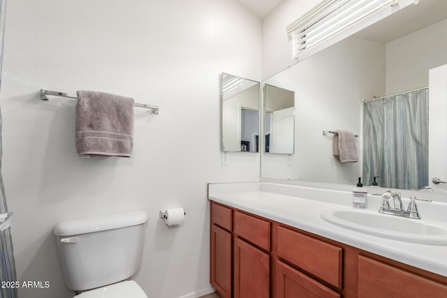 1350 S Greenfield Rd Unit 1005, Mesa, AZ 85206 - bathroom with vanity, toilet, and baseboards