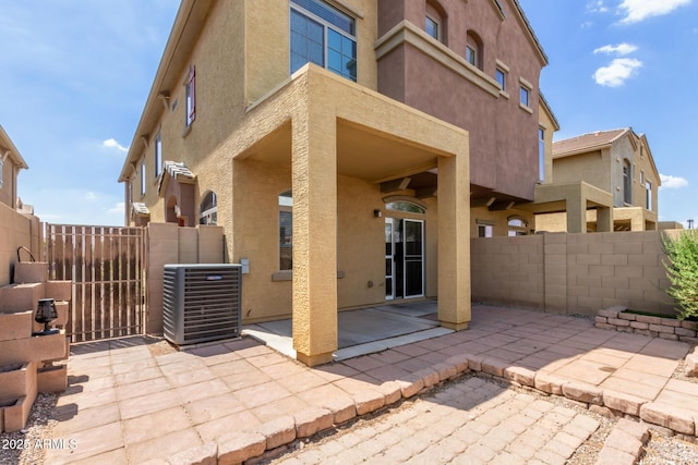 1350 S Greenfield Rd Unit 1005, Mesa, AZ 85206 - view of patio featuring central AC and a gate