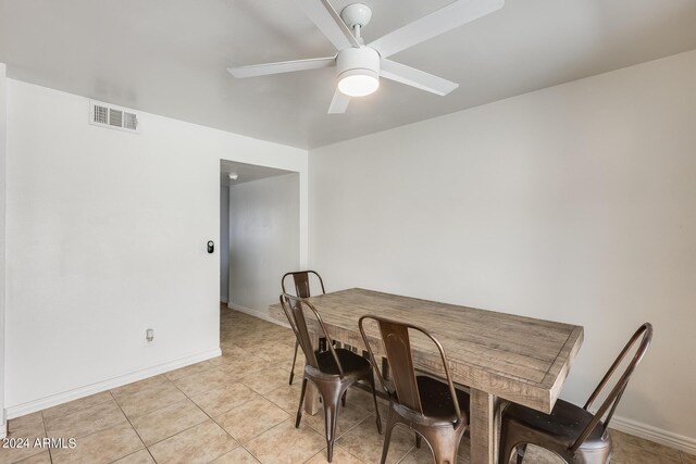 tiled dining room with ceiling fan