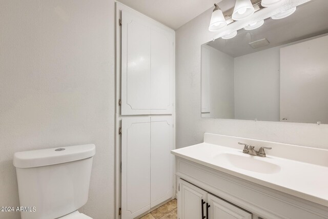 bathroom with vanity, toilet, and tile patterned floors