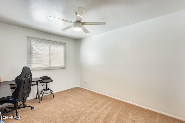 carpeted office featuring ceiling fan