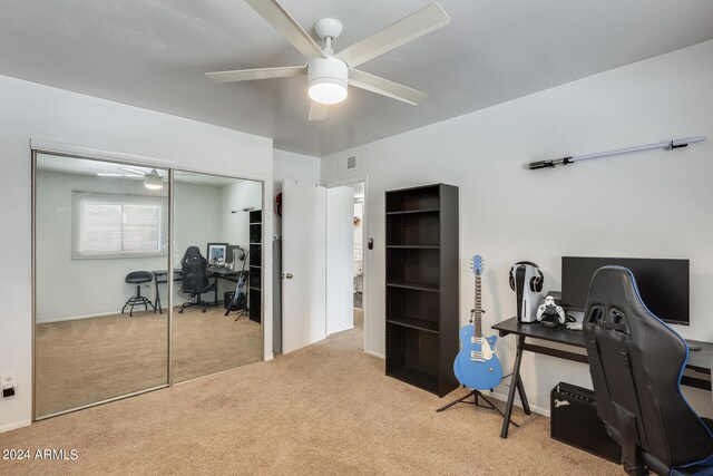 home office with ceiling fan and light carpet