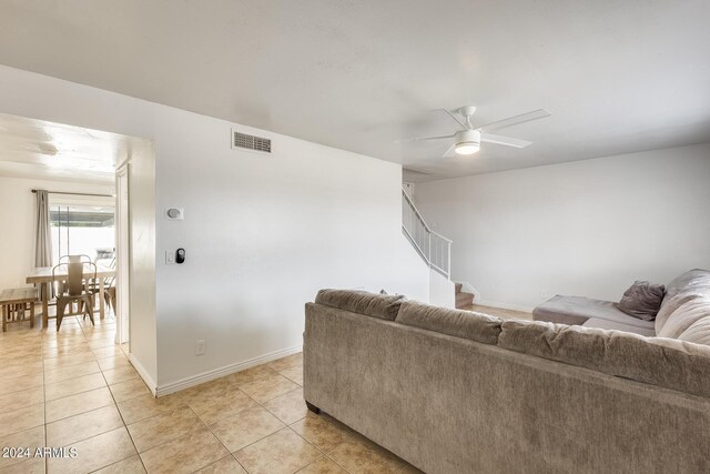 tiled living room with ceiling fan