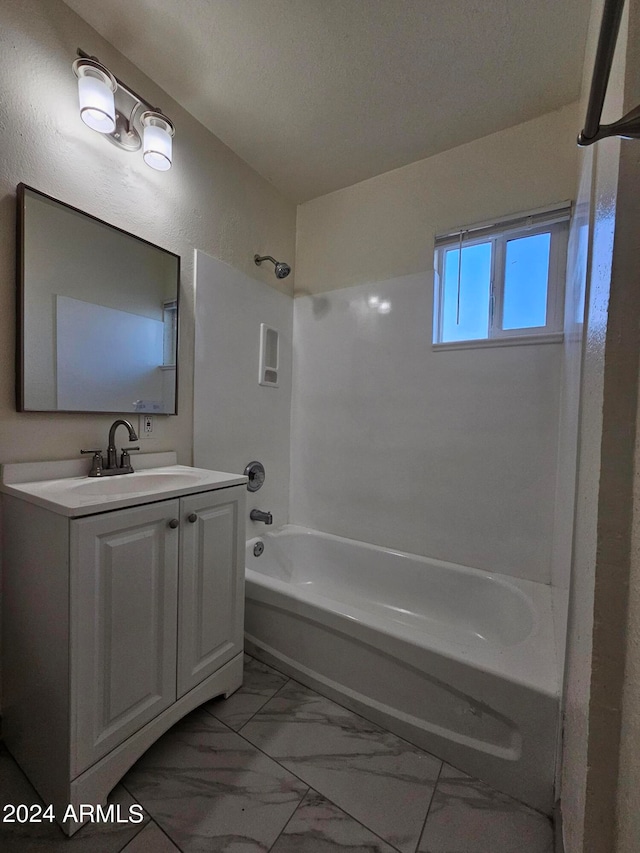 bathroom with vanity, a textured ceiling, and bathing tub / shower combination