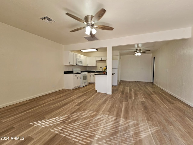 unfurnished living room with sink, light hardwood / wood-style flooring, and ceiling fan