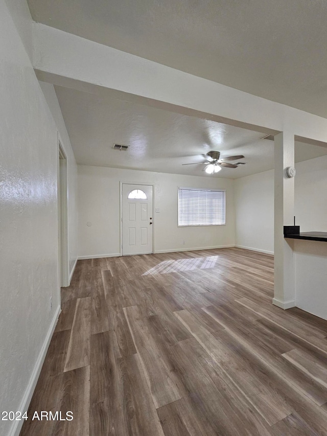 entryway with wood-type flooring and ceiling fan