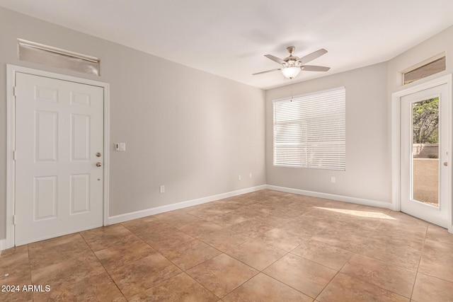 unfurnished room with light tile patterned flooring and ceiling fan