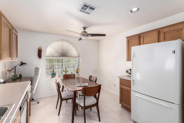 dining area featuring ceiling fan and sink