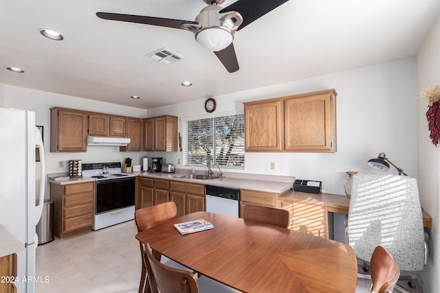 kitchen featuring white appliances, ceiling fan, and sink