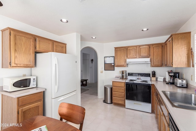 kitchen with sink and white appliances