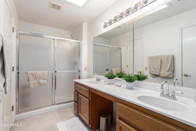 bathroom featuring vanity and a shower with door