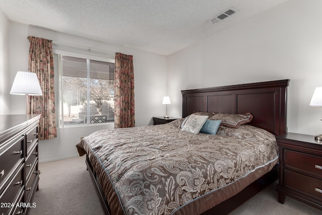 carpeted bedroom with a textured ceiling