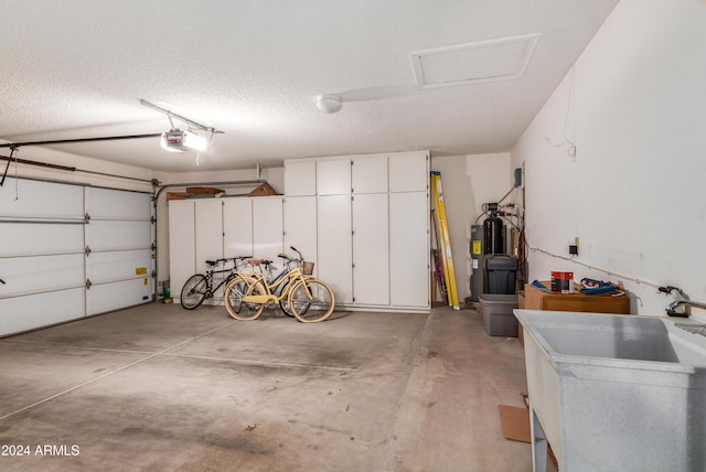 garage with a garage door opener and sink