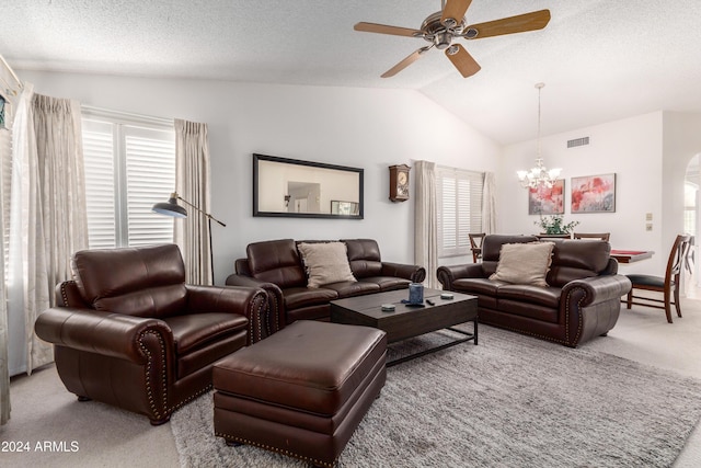 carpeted living room with a textured ceiling, ceiling fan with notable chandelier, and vaulted ceiling