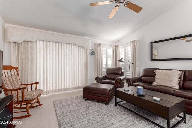 carpeted living room featuring a textured ceiling, ceiling fan, and lofted ceiling