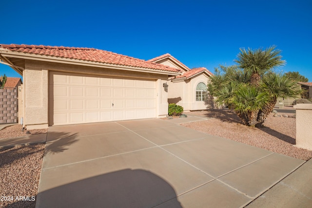 mediterranean / spanish-style home featuring a garage