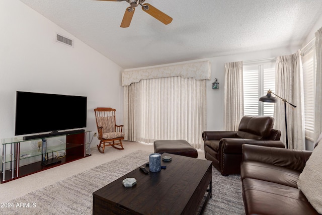 living room featuring carpet, a textured ceiling, ceiling fan, and lofted ceiling