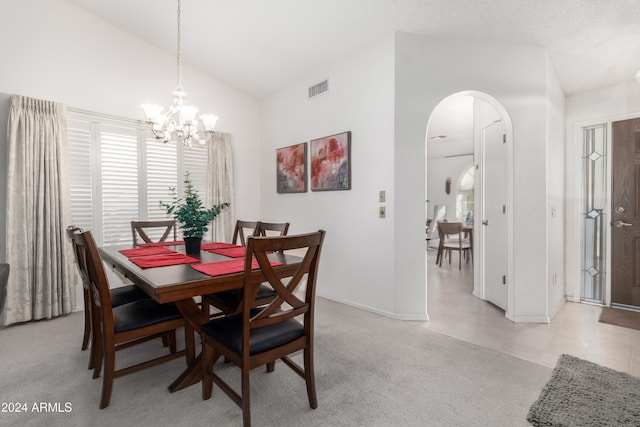 dining area featuring light colored carpet, lofted ceiling, and an inviting chandelier