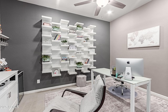 office featuring a ceiling fan and baseboards