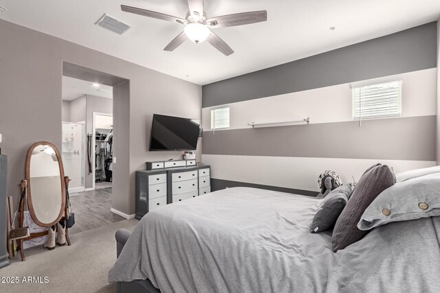 bedroom with baseboards, visible vents, a ceiling fan, a spacious closet, and a closet