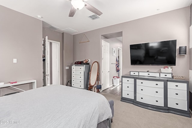 bedroom featuring ceiling fan, a spacious closet, light carpet, and visible vents