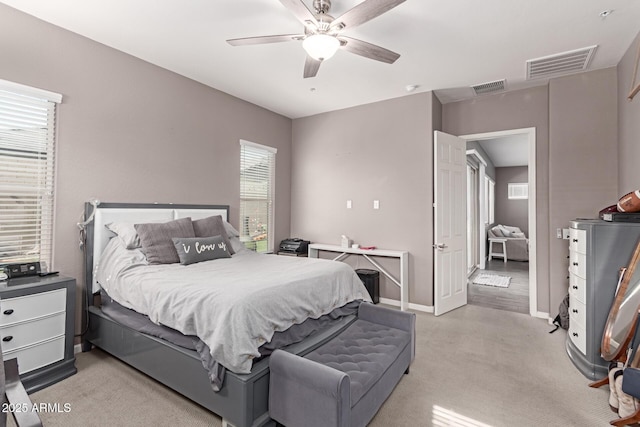 bedroom featuring baseboards, a ceiling fan, visible vents, and light colored carpet