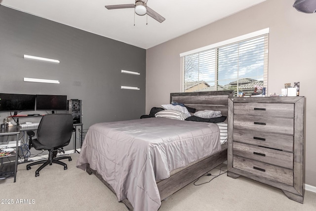 bedroom with light carpet, ceiling fan, and baseboards