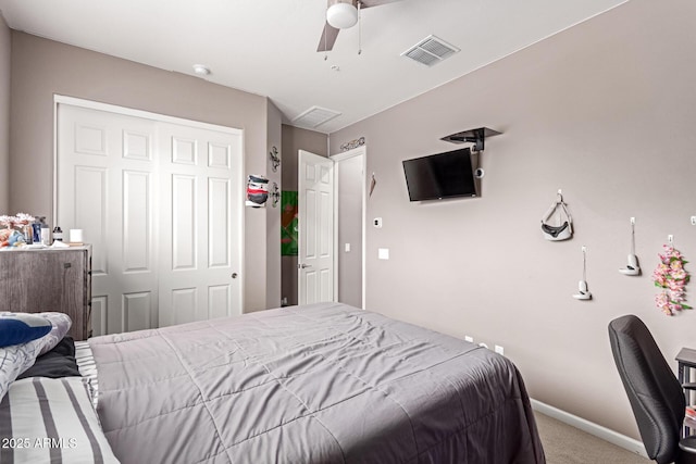 carpeted bedroom with baseboards, ceiling fan, visible vents, and a closet