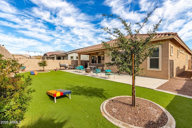 back of property featuring a patio, a fenced backyard, a tiled roof, a yard, and stucco siding