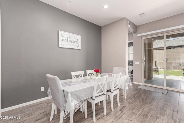 dining room featuring baseboards and wood finished floors