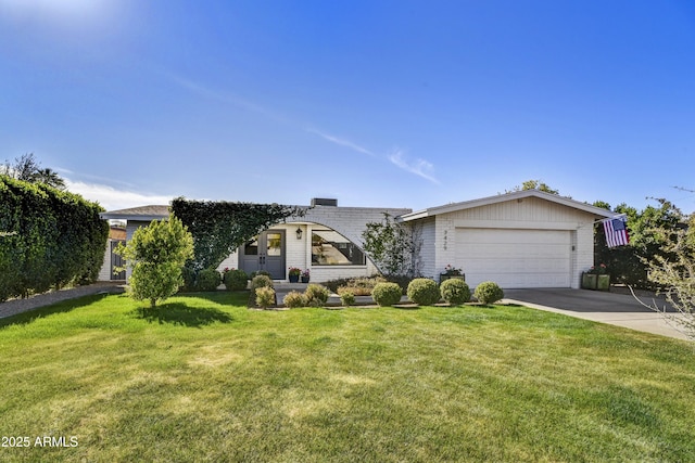 view of front of house with a garage and a front lawn