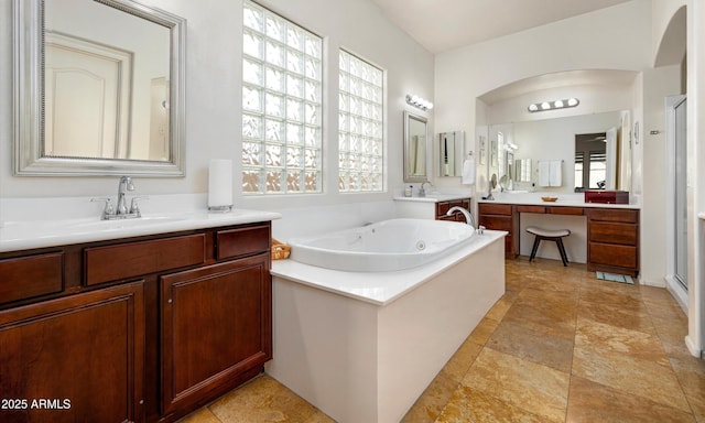 bathroom with vanity and shower with separate bathtub