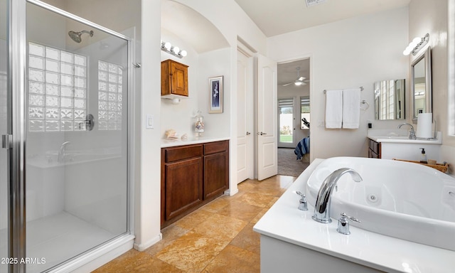 bathroom with ceiling fan, vanity, and independent shower and bath