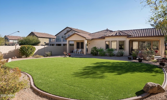 rear view of property with a lawn