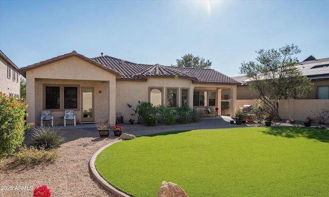 back of house featuring a yard and a patio